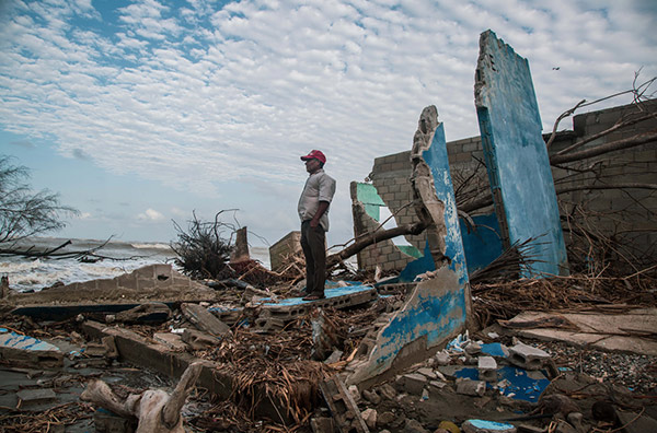 a damaged building on a shoreline